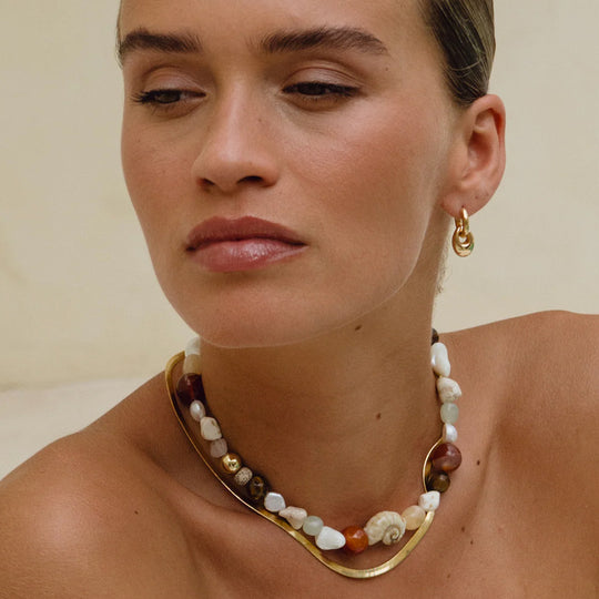 A neat, fluid chain with a slightly sculptural feel, the Snake Charmer Necklace sits cleanly along the collarbone and moves naturally with the wearer.