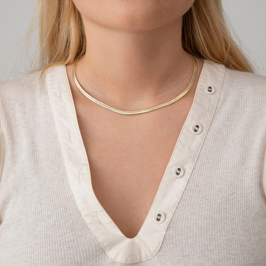 A neat, fluid chain with a slightly sculptural feel, the Snake Charmer Necklace sits cleanly along the collarbone and moves naturally with the wearer.