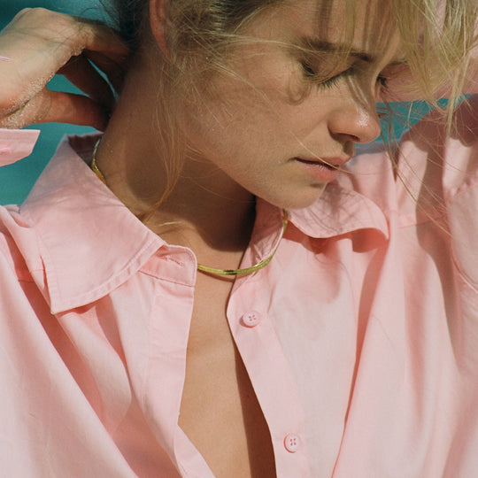 A neat, fluid chain with a slightly sculptural feel, the Snake Charmer Necklace sits cleanly along the collarbone and moves naturally with the wearer.