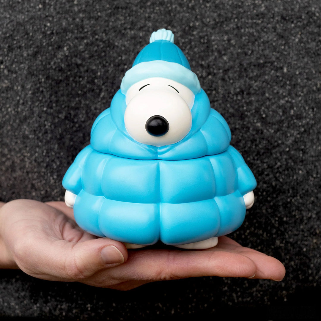 inspired by Charles Schulz’s classic comic strip, showcases Snoopy in his iconic, oversized puffy coat