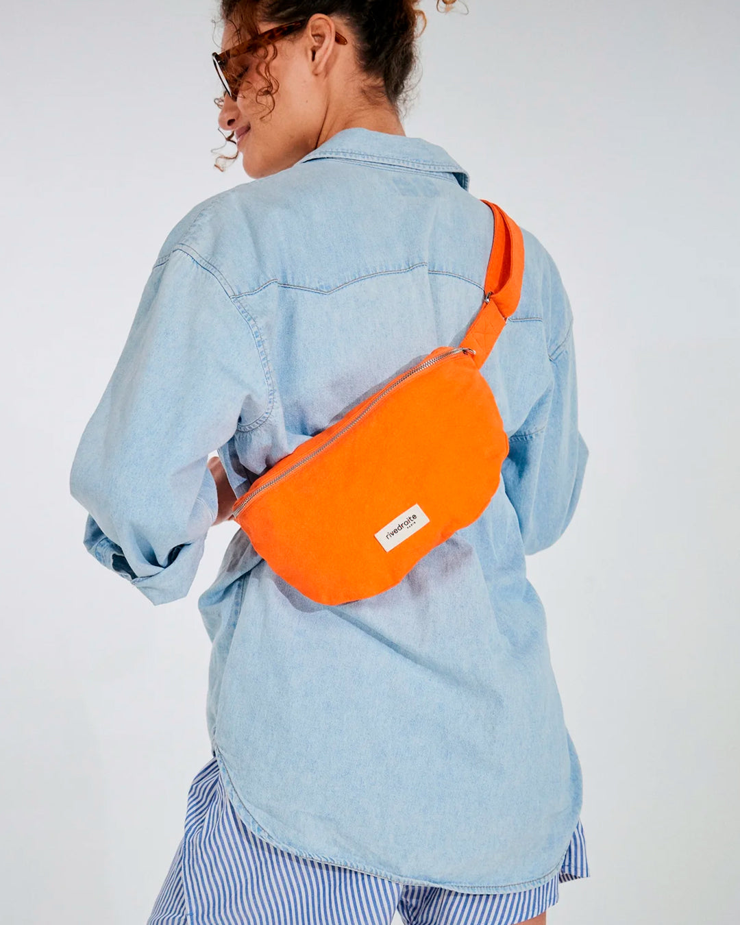 The Custine Belt Bag by Rive Droite Paris is a compact belt bag made from a bright Soda Orange recycled cotton fabric.