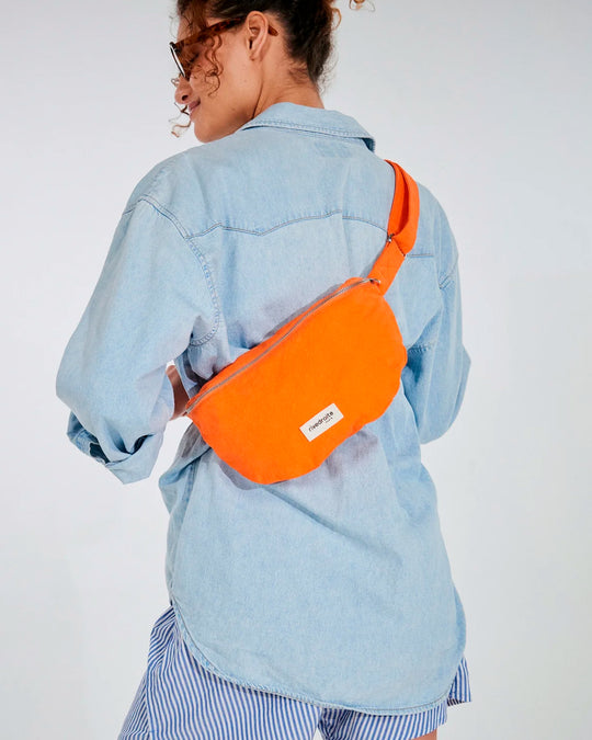 The Custine Belt Bag by Rive Droite Paris is a compact belt bag made from a bright Soda Orange recycled cotton fabric.