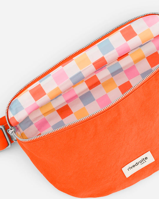The Custine Belt Bag by Rive Droite Paris is a compact belt bag made from a bright Soda Orange recycled cotton fabric.