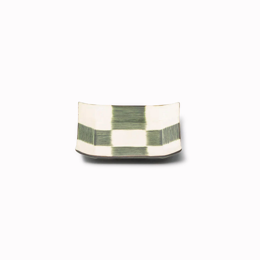 The Oribe Green Glaze features a mottled green with a yellow underglaze. Each piece has a unique dappled pattern determined by its position in the kiln during the firing process.
