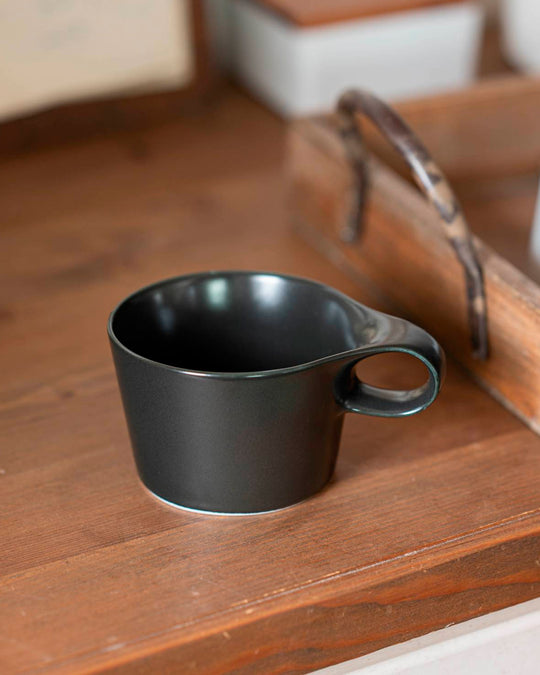 The Stamug is a porcelain mug with 150ml capacity for tea or shorter coffee drinks. Finished in an even matt black glaze.