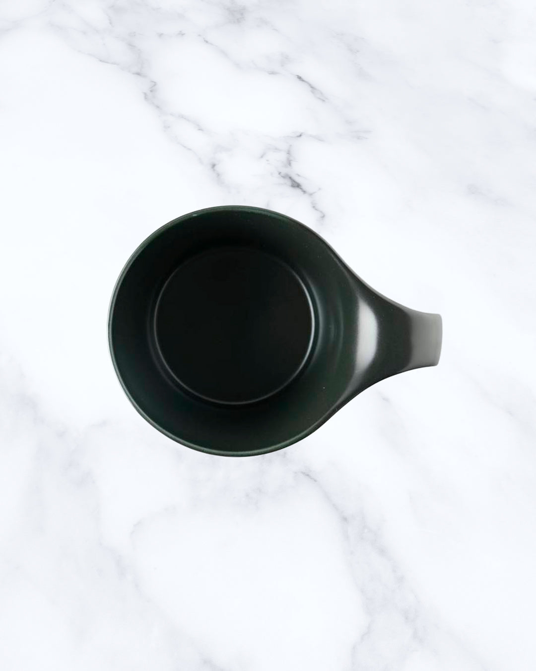 The Stamug is a porcelain mug with 150ml capacity for tea or shorter coffee drinks. Finished in an even matt black glaze.