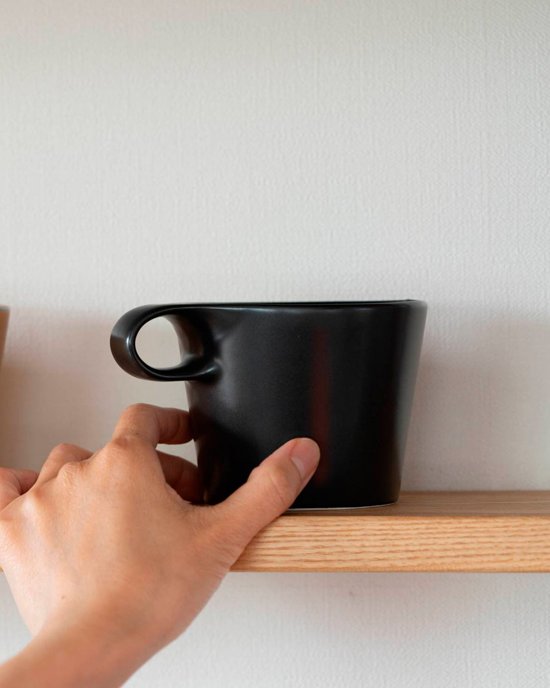 The Stamug is a porcelain mug with a compact 250ml capacity. Finished in an even matt black glaze.
