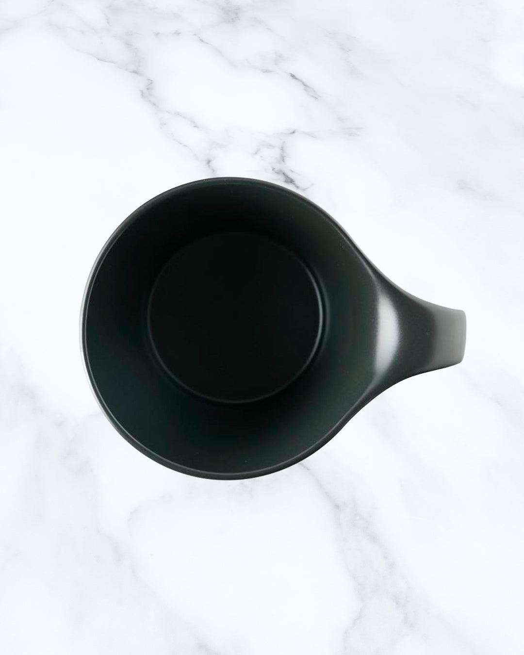 The Stamug is a porcelain mug with a compact 250ml capacity. Finished in an even matt black glaze.
