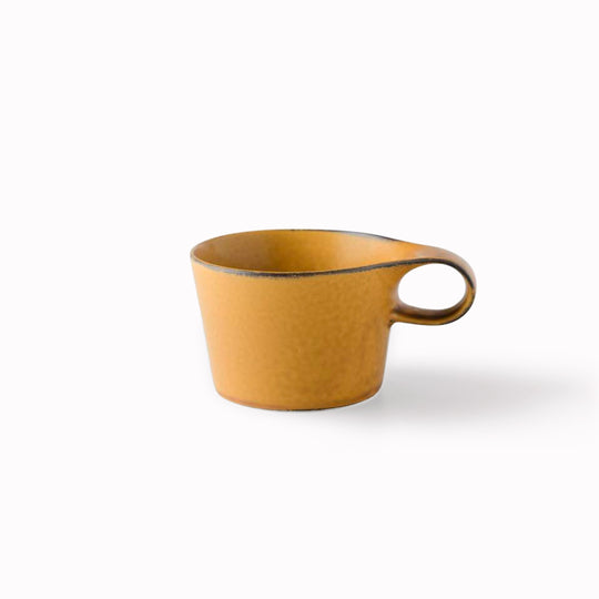 The Stamug is a porcelain mug with 150ml capacity for tea or shorter coffee drinks. Finished in a matt mustard glaze mixed with earthy brown tones.