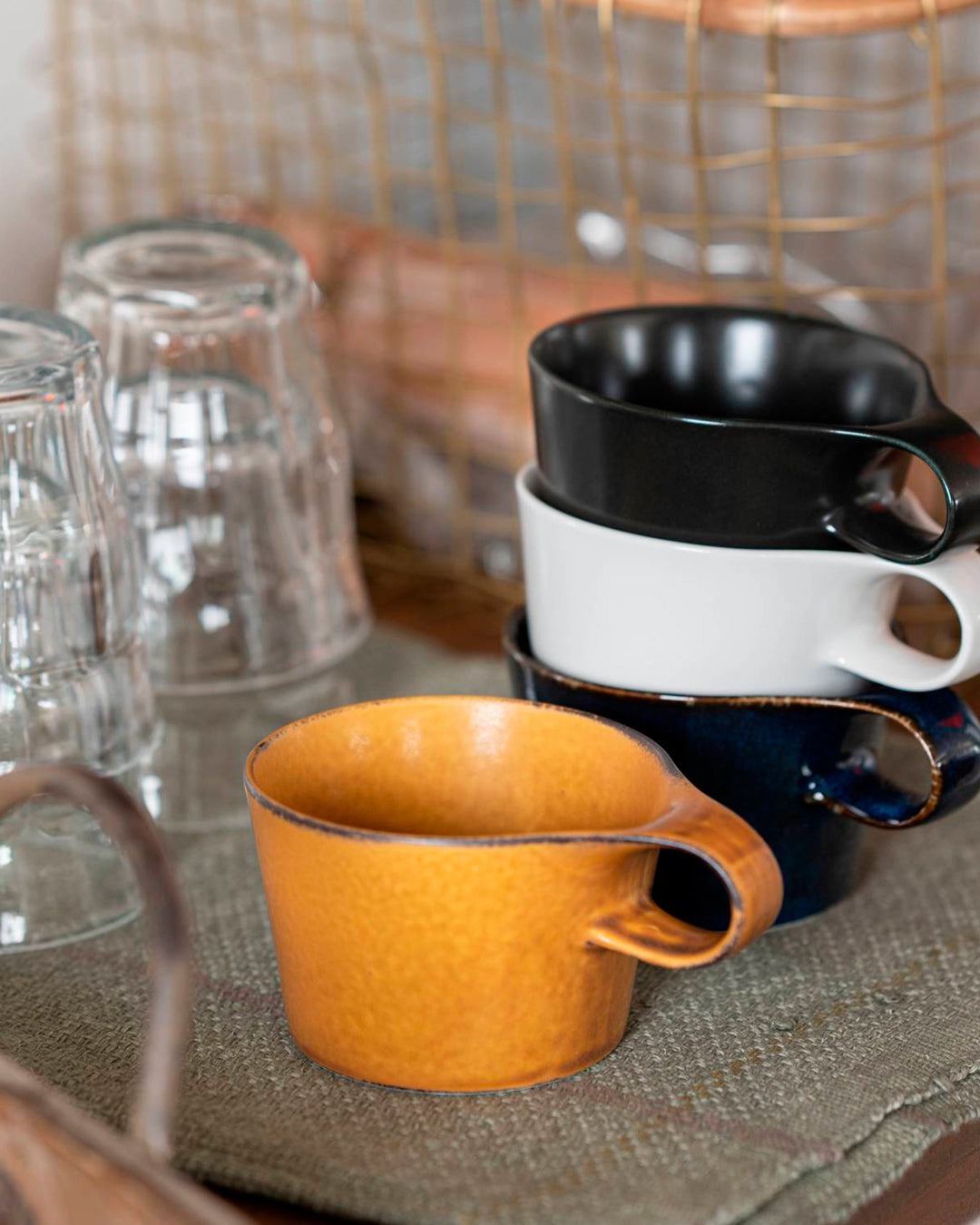 The Stamug is a porcelain mug with 150ml capacity for tea or shorter coffee drinks. Finished in a matt mustard glaze mixed with earthy brown tones.