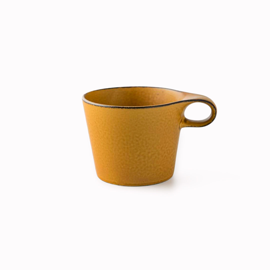 The Stamug is a porcelain mug with a compact 250ml capacity. Finished in a matt mustard glaze mixed with earthy brown tones. This glaze has natural variations in tone.