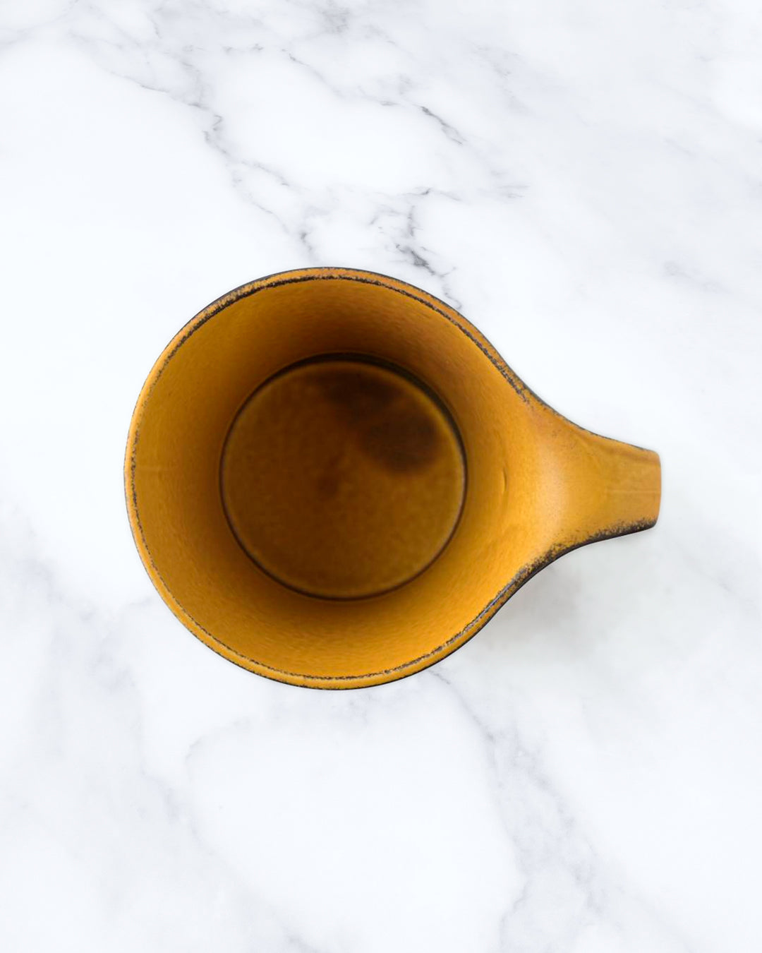 The Stamug is a porcelain mug with a compact 250ml capacity. Finished in a matt mustard glaze mixed with earthy brown tones. This glaze has natural variations in tone.