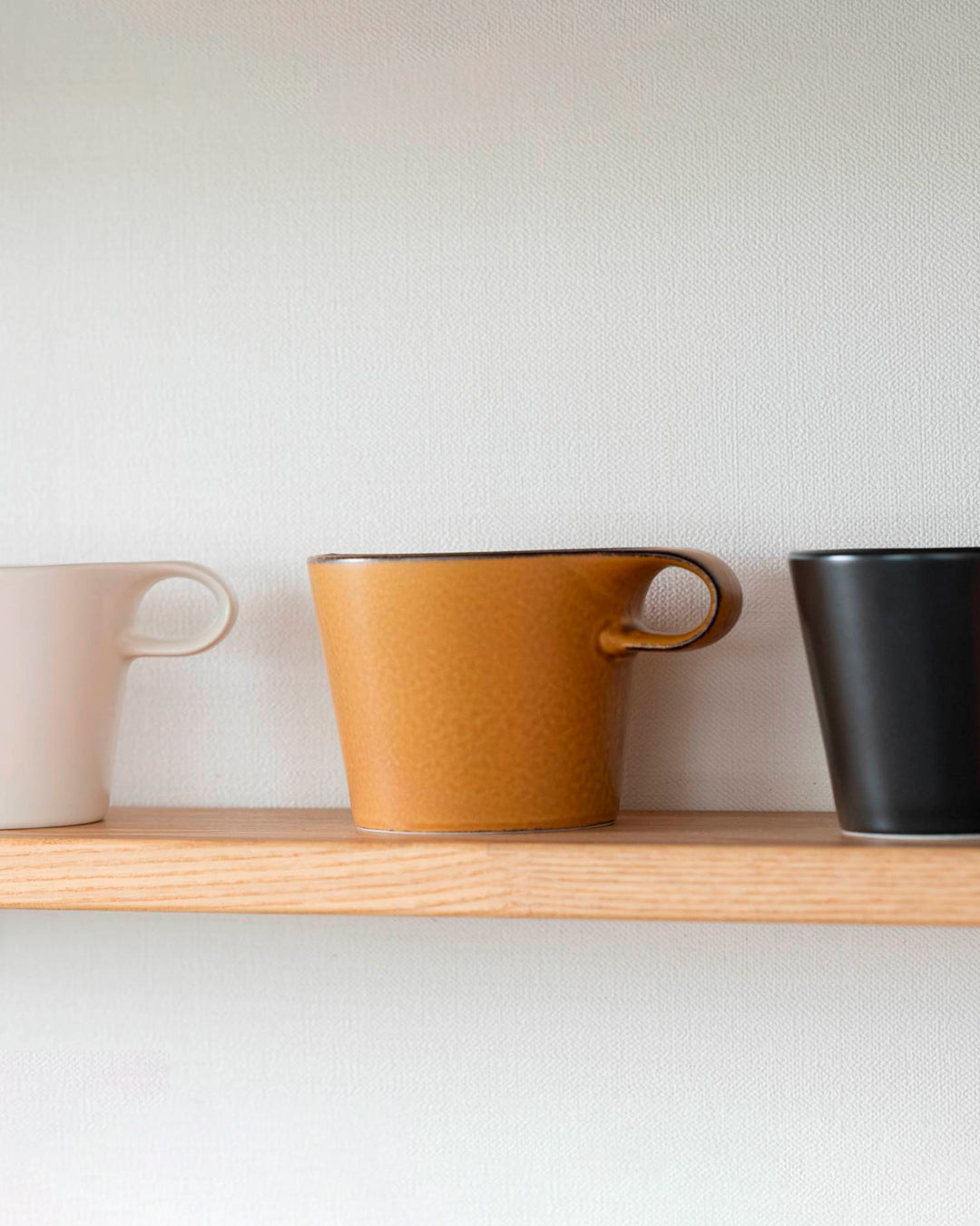 The Stamug is a porcelain mug with a compact 250ml capacity. Finished in a matt mustard glaze mixed with earthy brown tones. This glaze has natural variations in tone.