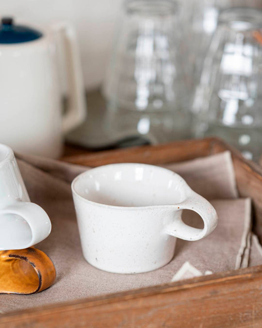 The Stamug is a porcelain mug with 150ml capacity for tea or shorter coffee drinks. Finished in a white kiln gloss glaze with a soft slightly speckled finish.