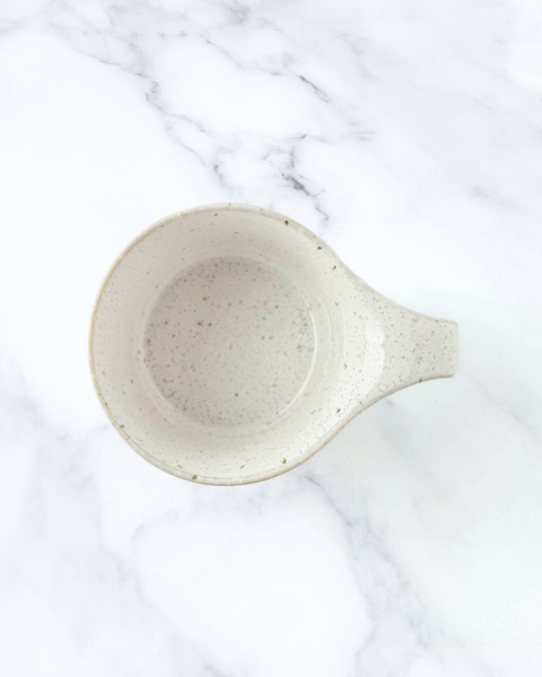 The Stamug is a porcelain mug with 150ml capacity for tea or shorter coffee drinks. Finished in a white kiln gloss glaze with a soft slightly speckled finish.