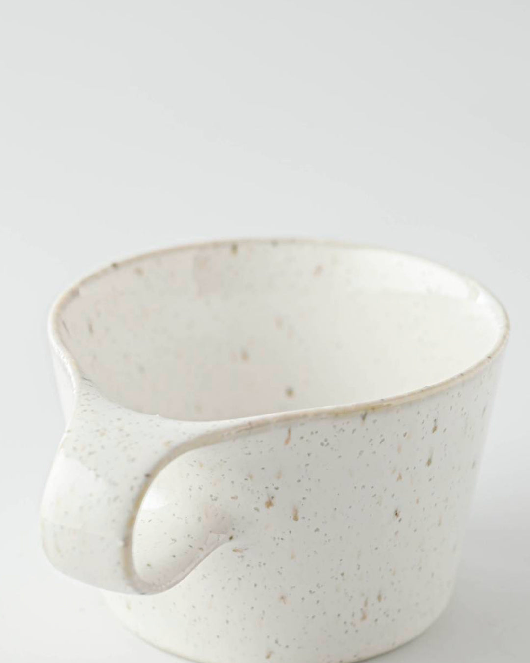 The Stamug is a porcelain mug with 150ml capacity for tea or shorter coffee drinks. Finished in a white kiln gloss glaze with a soft slightly speckled finish.