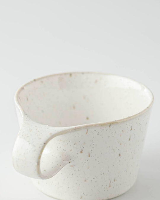 The Stamug is a porcelain mug with 150ml capacity for tea or shorter coffee drinks. Finished in a white kiln gloss glaze with a soft slightly speckled finish.