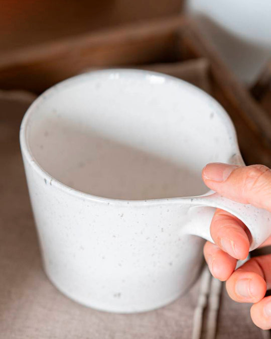 The Stamug is a porcelain mug with a compact 250ml capacity, finished in a white kiln gloss glaze with a soft slightly speckled finish.