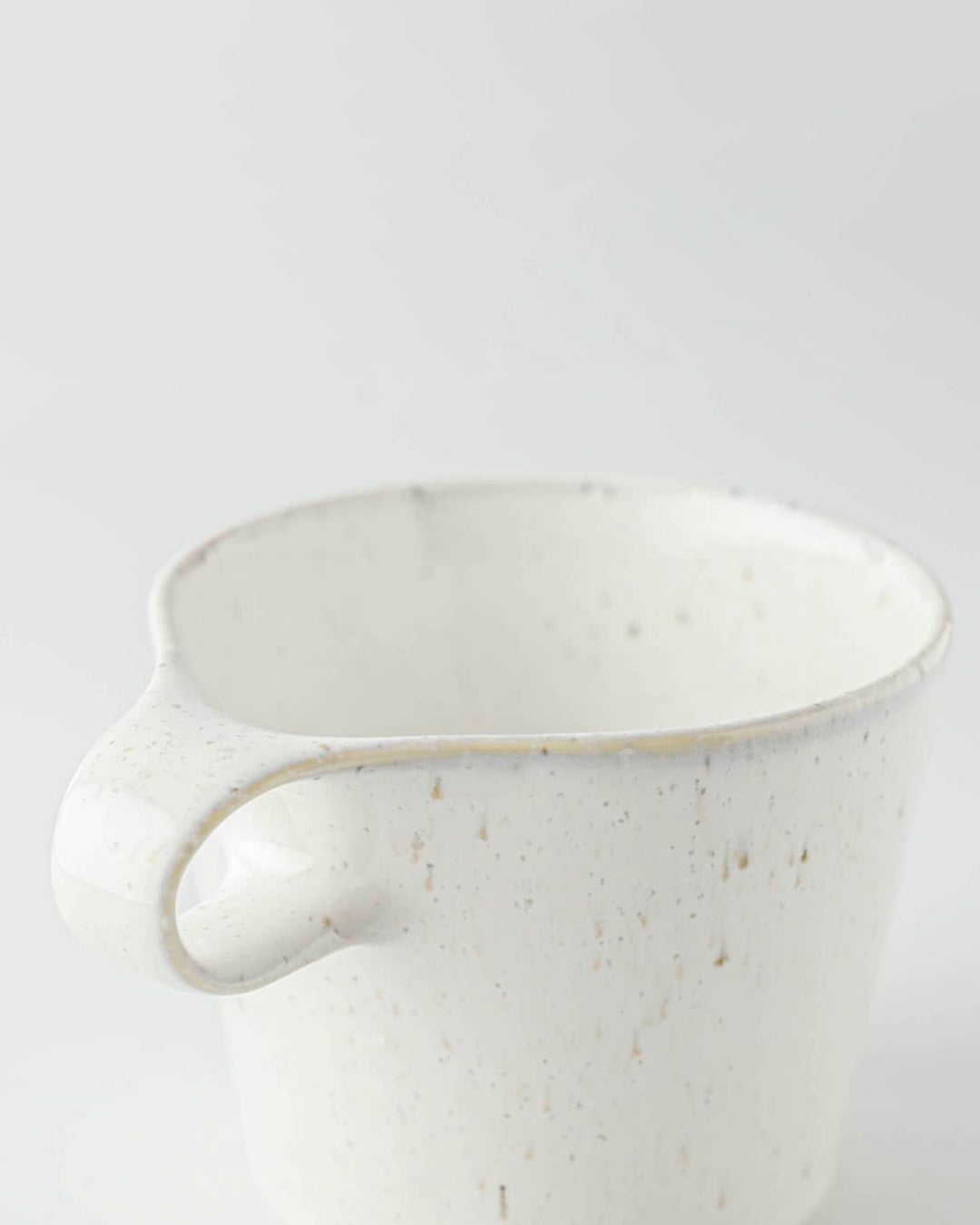 The Stamug is a porcelain mug with a compact 250ml capacity, finished in a white kiln gloss glaze with a soft slightly speckled finish.