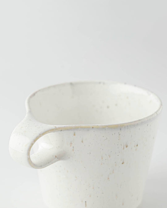 The Stamug is a porcelain mug with a compact 250ml capacity, finished in a white kiln gloss glaze with a soft slightly speckled finish.