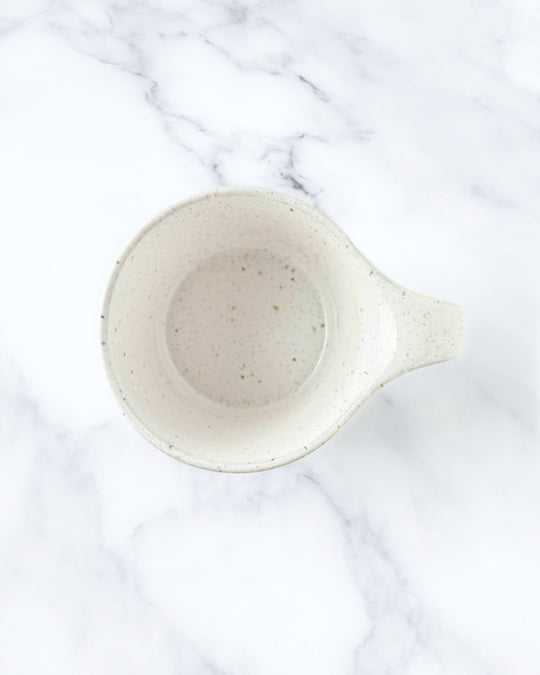 The Stamug is a porcelain mug with a compact 250ml capacity, finished in a white kiln gloss glaze with a soft slightly speckled finish.