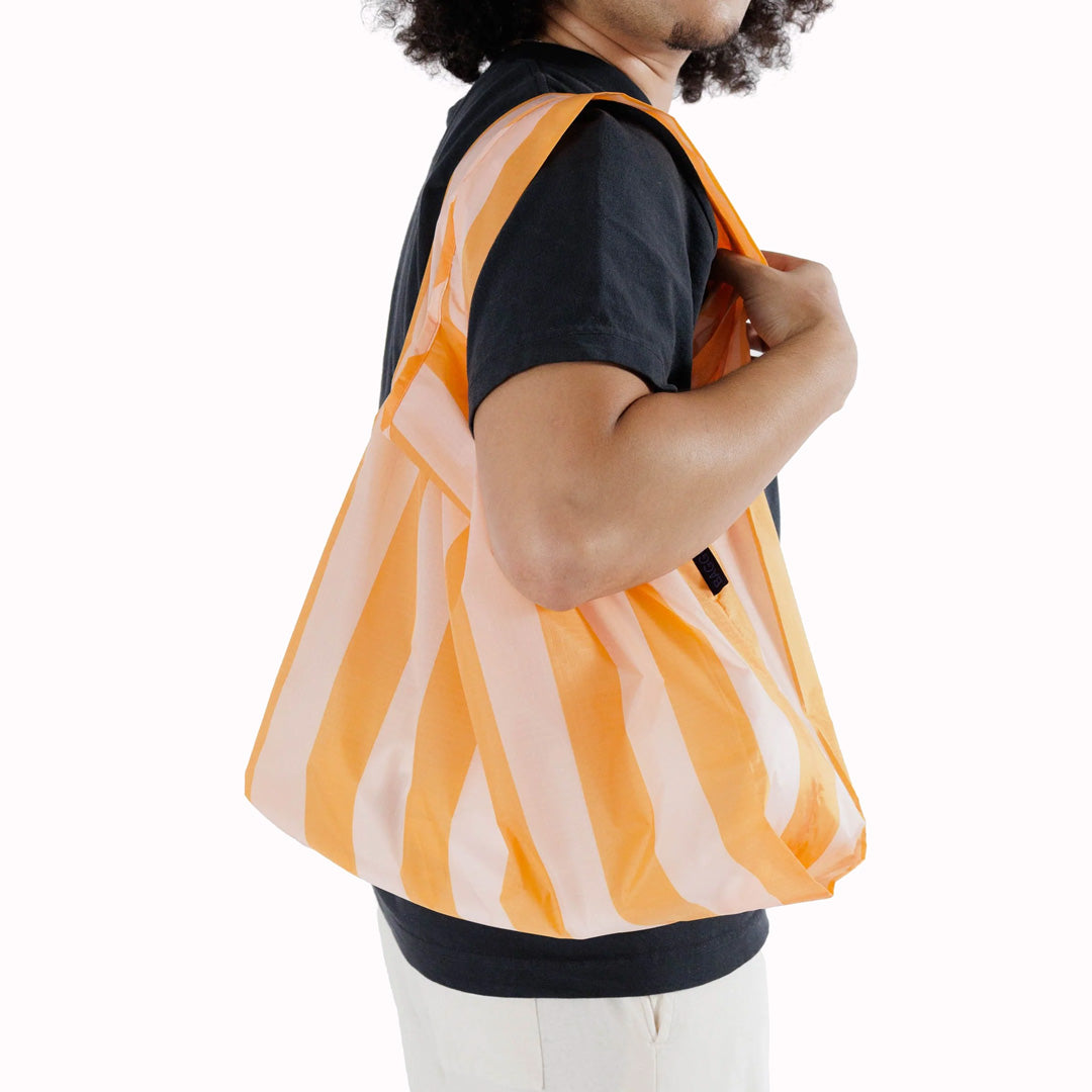 As Worn - Tangerine Striped reusable shopping bag from Californian maker Baggu made from super strong ripstop nylon to transport pretty much anything, so long as it’s under 20kg.