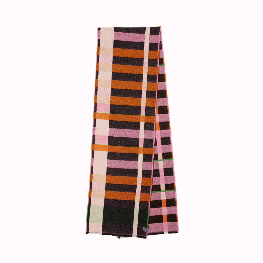 The Stölzl Lambswool Scarf from Wallace and Sewell showcases the design of Gunta Stölzl’s original ‘Prellerdecke’ blanket. The Nougat colour scheme displays a mid tone design that is warm, its pinks and ochre hue influenced by Paul Klee's painting 'Senecio'.