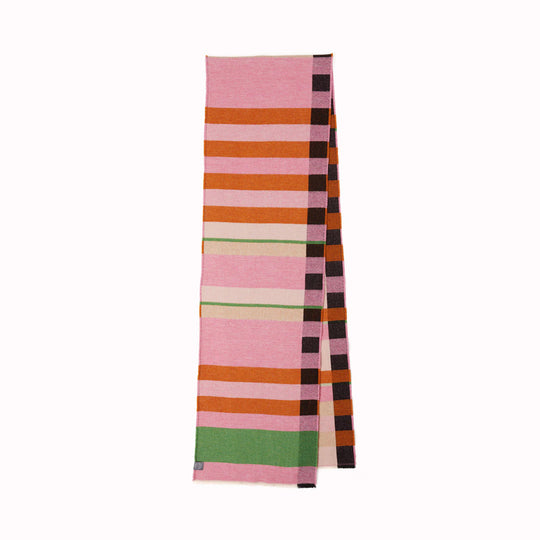 The Stölzl Lambswool Scarf from Wallace and Sewell showcases the design of Gunta Stölzl’s original ‘Prellerdecke’ blanket. The Nougat colour scheme displays a mid tone design that is warm, its pinks and ochre hue influenced by Paul Klee's painting 'Senecio'.