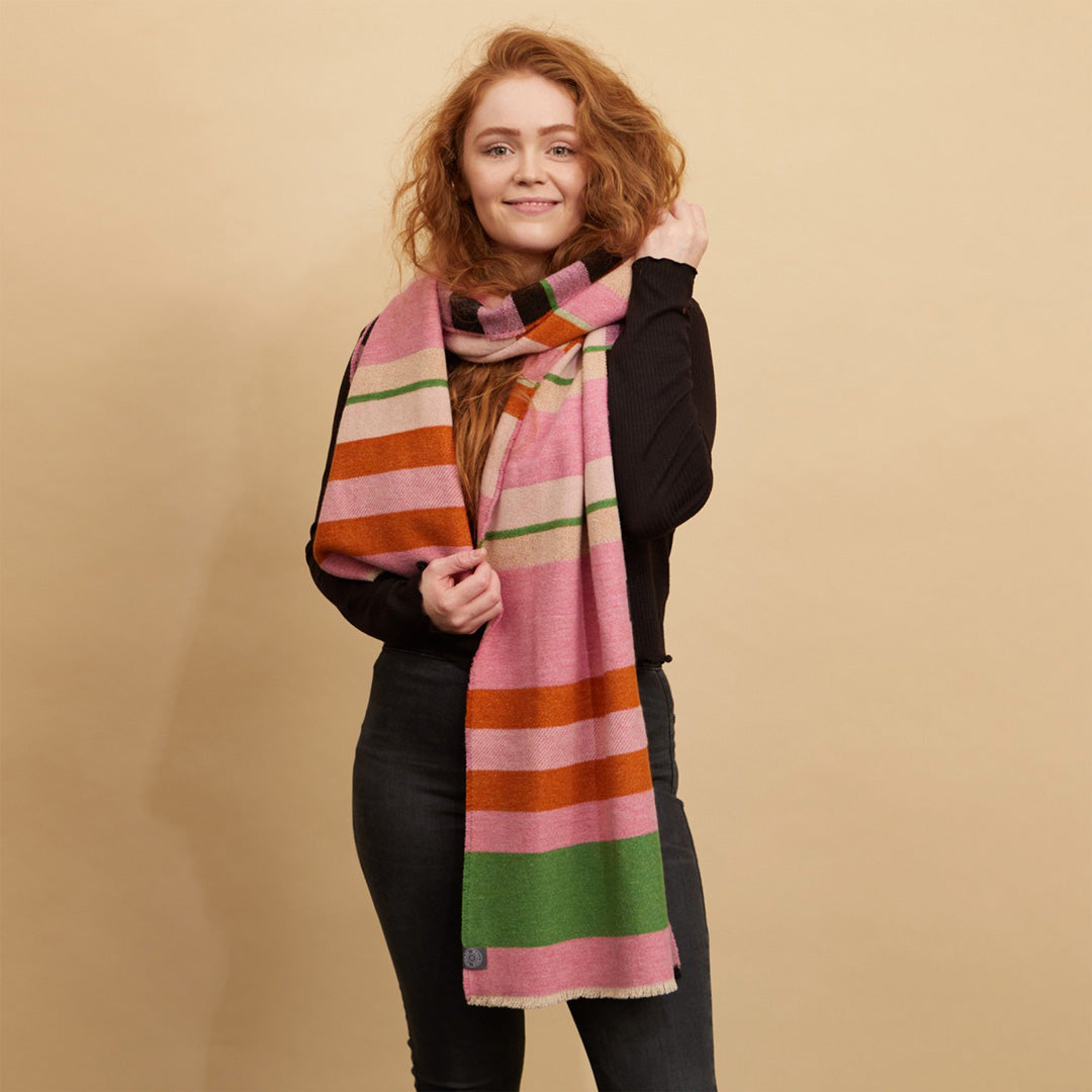 The Stölzl Lambswool Scarf from Wallace and Sewell showcases the design of Gunta Stölzl’s original ‘Prellerdecke’ blanket. The Nougat colour scheme displays a mid tone design that is warm, its pinks and ochre hue influenced by Paul Klee's painting 'Senecio'.
