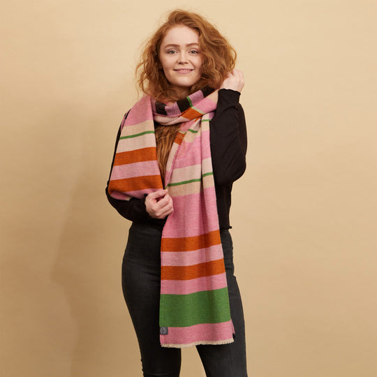 The Stölzl Lambswool Scarf from Wallace and Sewell showcases the design of Gunta Stölzl’s original ‘Prellerdecke’ blanket. The Nougat colour scheme displays a mid tone design that is warm, its pinks and ochre hue influenced by Paul Klee's painting 'Senecio'.
