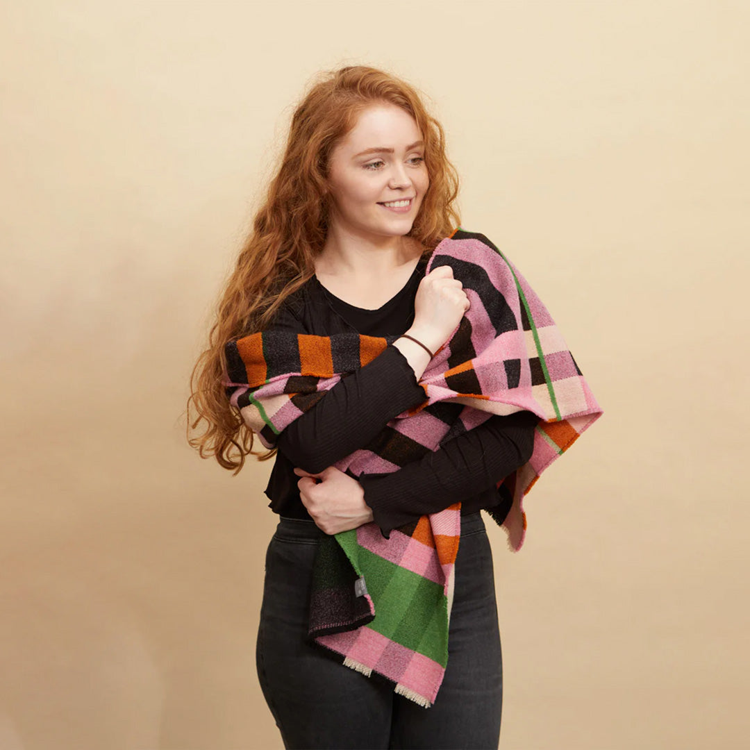 The Stölzl Lambswool Scarf from Wallace and Sewell showcases the design of Gunta Stölzl’s original ‘Prellerdecke’ blanket. The Nougat colour scheme displays a mid tone design that is warm, its pinks and ochre hue influenced by Paul Klee's painting 'Senecio'.