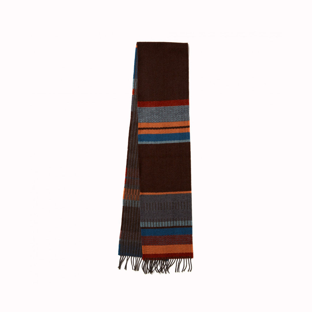 The Strathay Cinder Lambswool scarf by Wallace and Sewell is a 100% Merino Lambswool scarf displaying a deep peat palette and berry red tones to add warmth, while the burst of orange adds a lively touch.