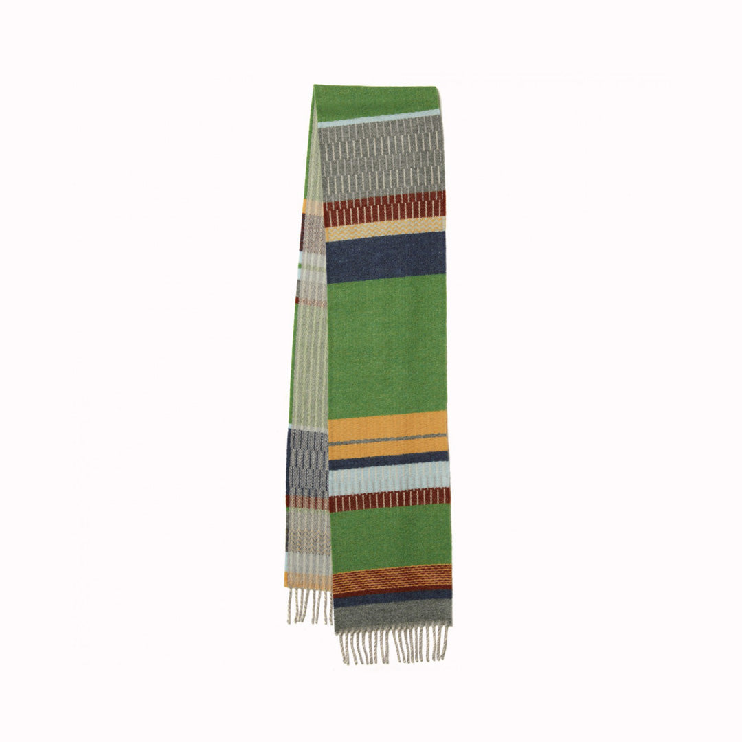 The Strathay Pea Lambswool scarf by Wallace and Sewell is a 100% Merino Lambswool scarf in a colourful pattern of pea greens, yellows and pale blues and greys. It is a testament to the intricate craft of textile design.