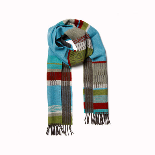 The Strathay Verdigris Lambswool scarf by Wallace and Sewell is a 100% Merino Lambswool scarf in a colourful pattern of verdigris blue, moss and orchard green, with a pop of dark red.