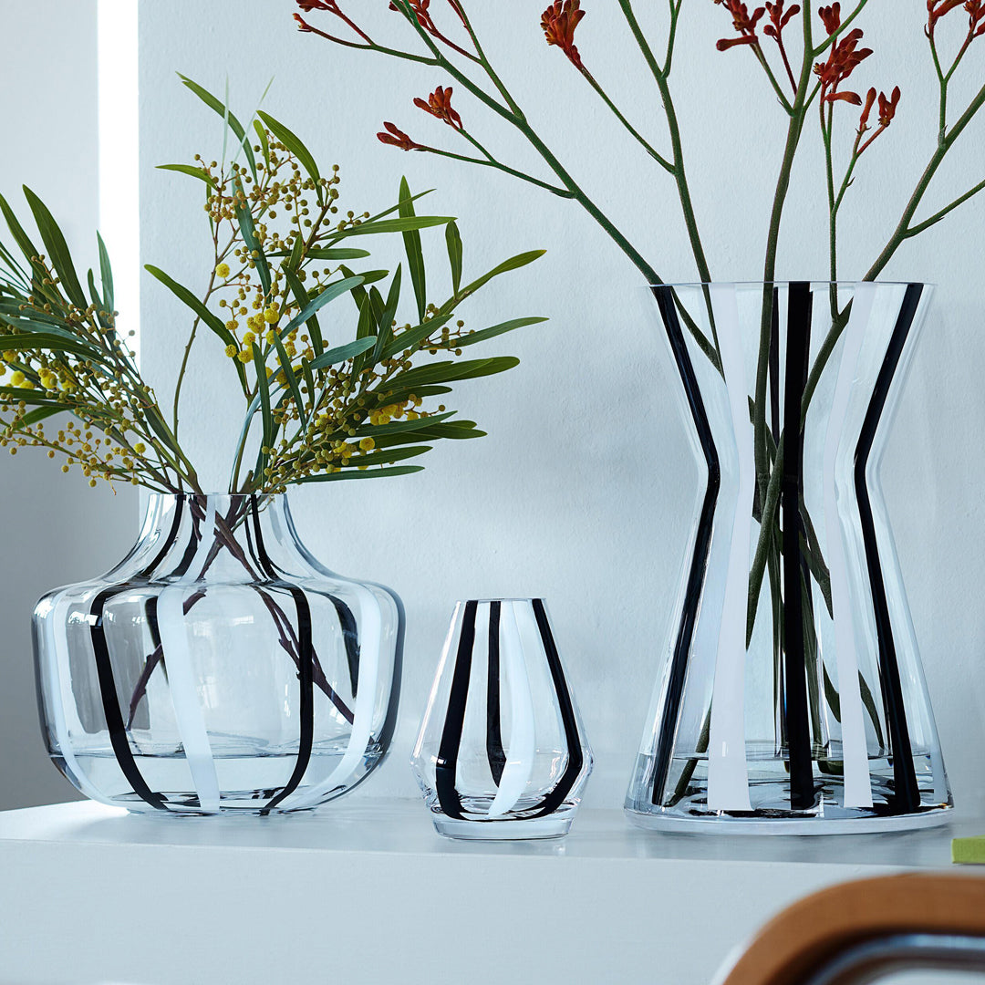 A show stopping bold and graphic black and white striped glass vase by LSA International. With hand applied stripes, each piece has slight variations which add to the artisan appeal of these mouth blown glass vases.&nbsp;