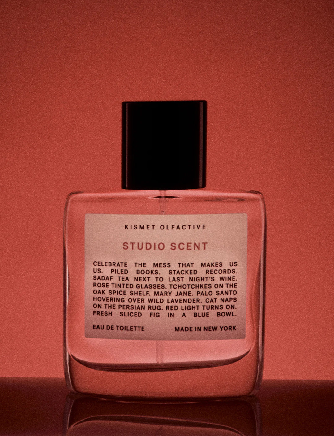 Studio Scent Perfume bottle with a label on a red background