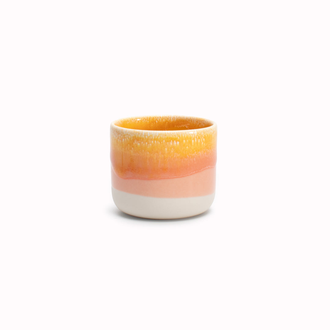 The strikingly yellow and orange Sip Cup, A Danish/Japanese mix up with this thick glazed, hand made ceramic small beaker from Studio Arhoj's Tokyo Series.
