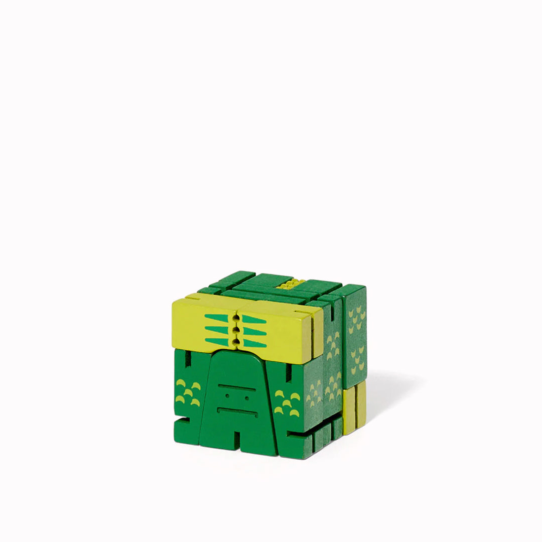 The Cubebot Cryptoids Swamp Creature is a wooden puzzle toy designed by David Weeks. This collectible item is constructed from durable beechwood and elastic