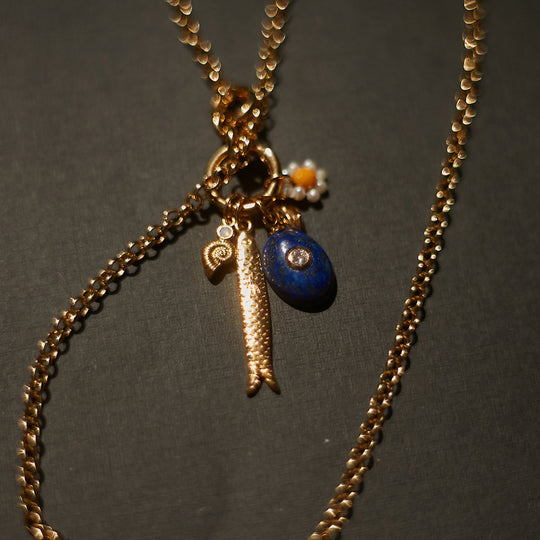 SWIMCLUB is a poolside daydream — pearls, lapis and golden details woven into playful elegance.