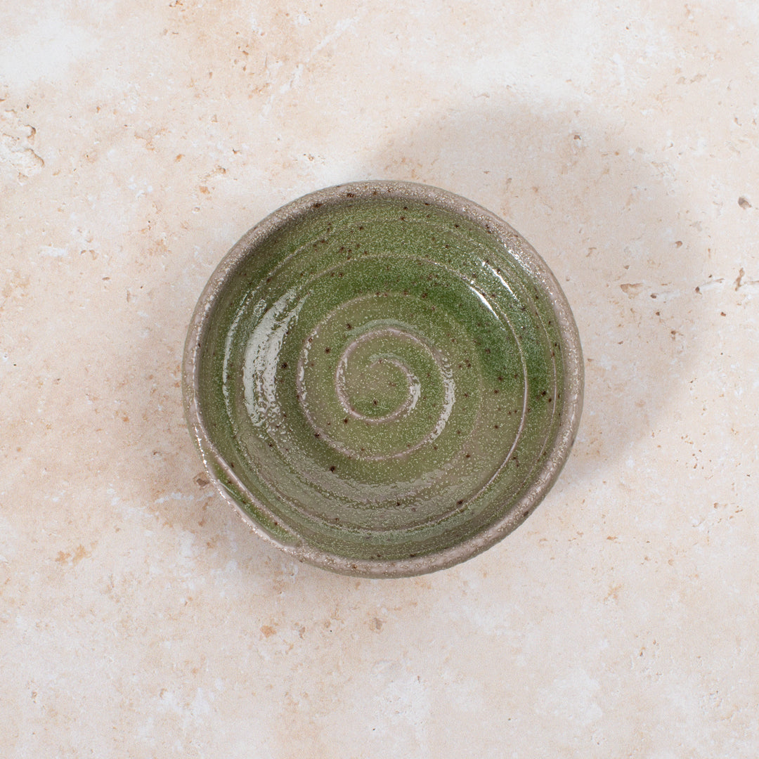 A mini serving dish made from Japanese mino ware, with Oribe green swirl pattern.