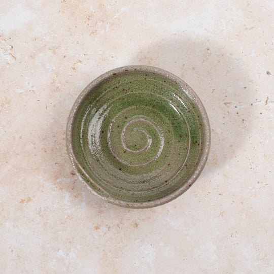 A mini serving dish made from Japanese mino ware, with Oribe green swirl pattern.