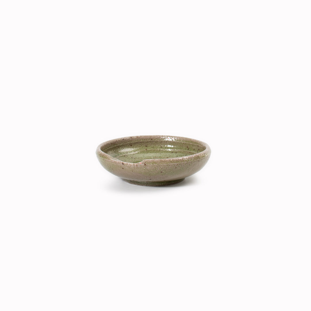 A mini serving dish made from Japanese mino ware, with Oribe green swirl pattern.