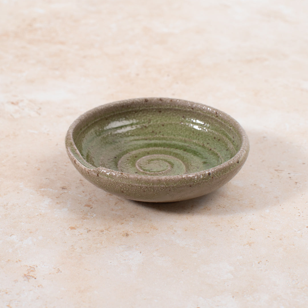 A mini serving dish made from Japanese mino ware, with Oribe green swirl pattern.