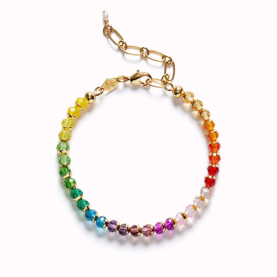 The Anni Lu Tennis Kinda Bracelet is a playful and elegant accessory that reimagines the classic tennis bracelet with a touch of charm. Infused with the vibrancy of a rainbow