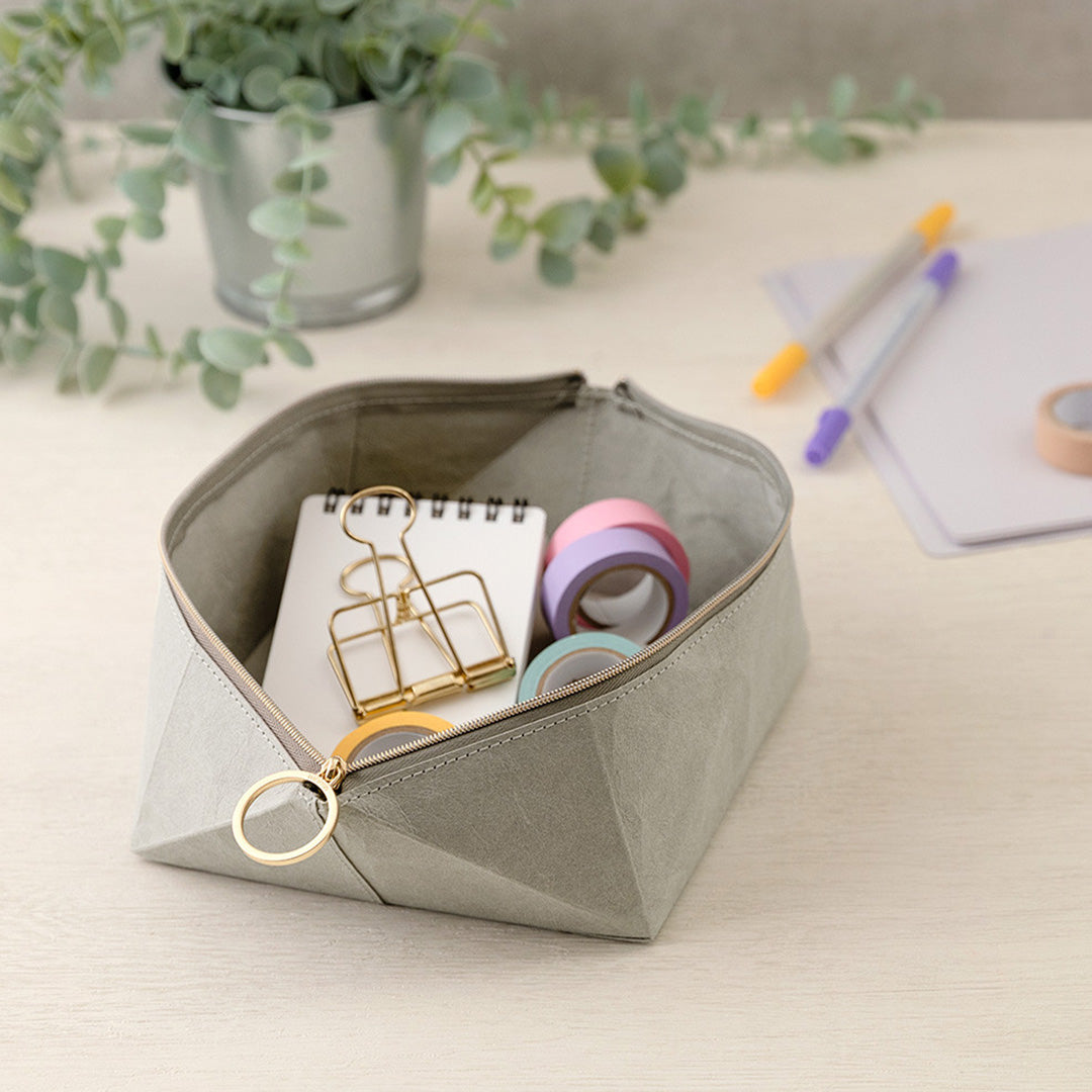 The tray pouch from, Midori Japan, is a desktop accessory holder made from a durable coated paper. The paper is lightweight, strong and tear resistant but also soft to the touch and will soften slightly over time.