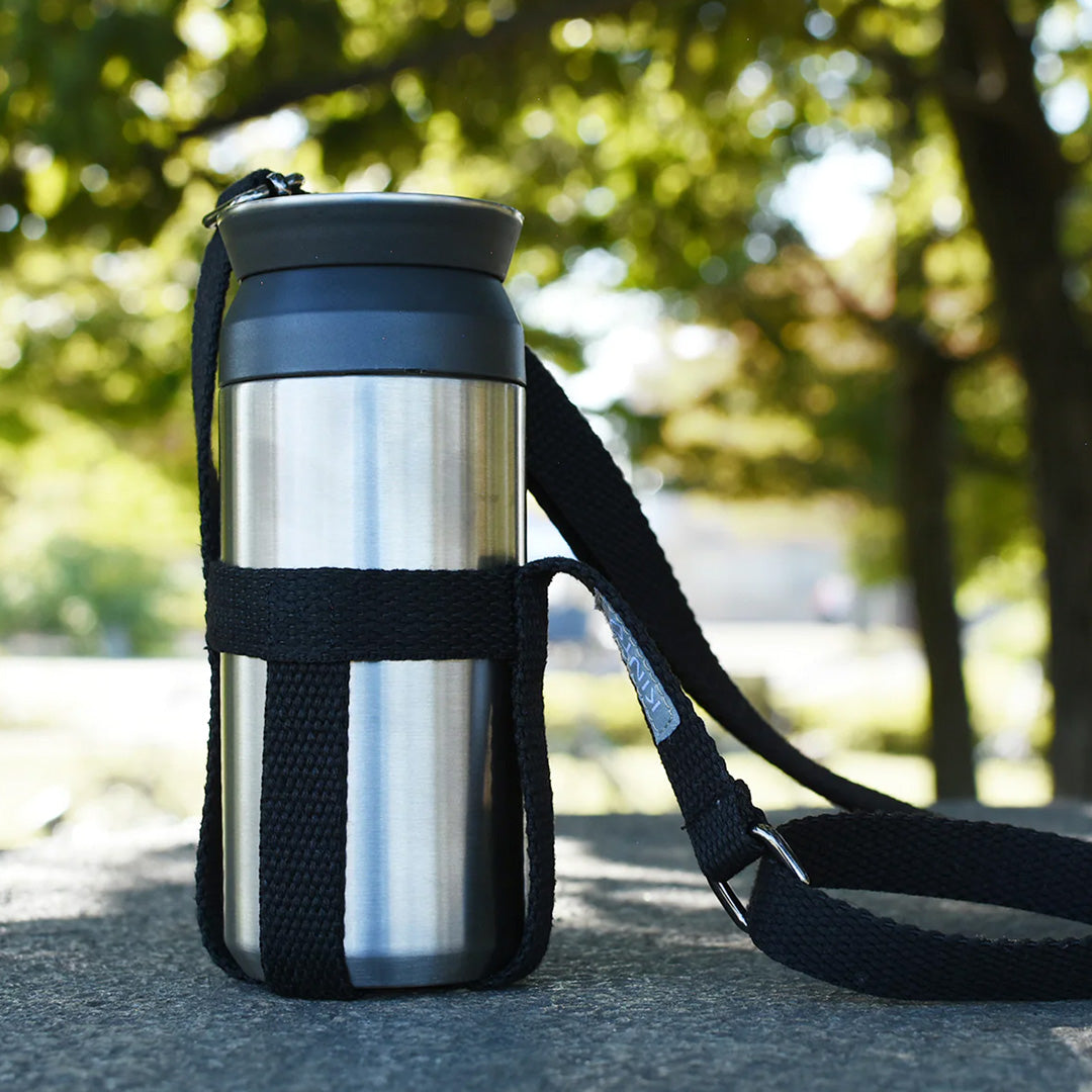 Travel Tumbler with strap. The black Tumbler Travel Strap from Kinto Japan is made of durable polyester and fits the Travel Tumbler water bottle (also available) perfectly. It is a stylish and convenient accessory for your daily commute or outdoor adventures.