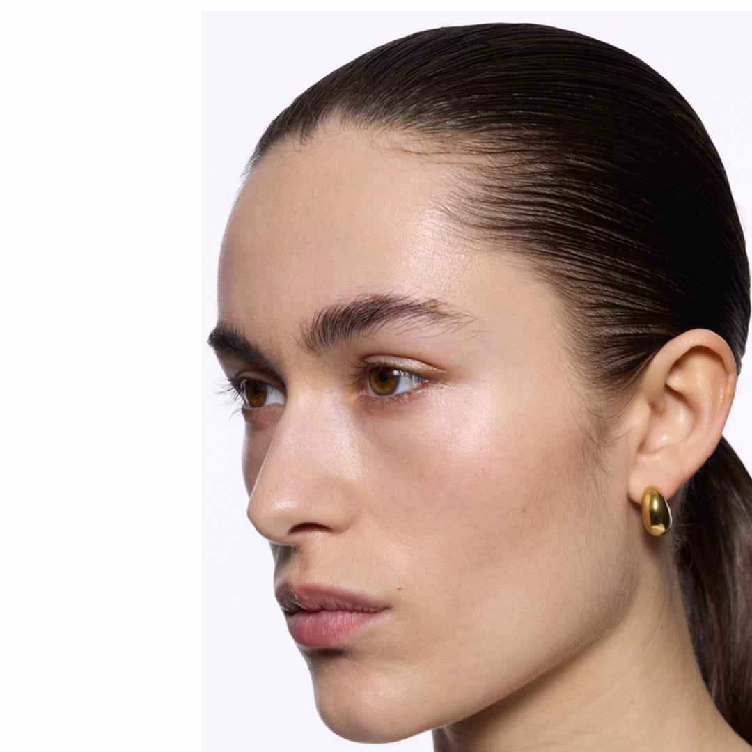 The Tryvann Pillow earring is designed in Denmark and skilfully crafted in 925 recycled sterling silver and plated with either White Rhodium or 18ct Gold, It is a chunky half-hoop earring that is Nickel free and hypoallergenic.