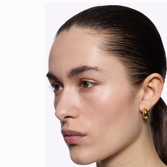 The Tryvann Pillow earring is designed in Denmark and skilfully crafted in 925 recycled sterling silver and plated with either White Rhodium or 18ct Gold, It is a chunky half-hoop earring that is Nickel free and hypoallergenic.