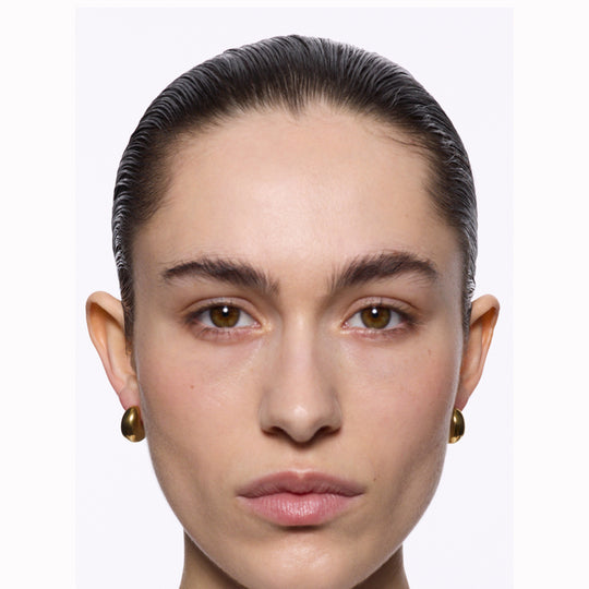 The Tryvann Pillow earring is designed in Denmark and skilfully crafted in 925 recycled sterling silver and plated with either White Rhodium or 18ct Gold, It is a chunky half-hoop earring that is Nickel free and hypoallergenic.