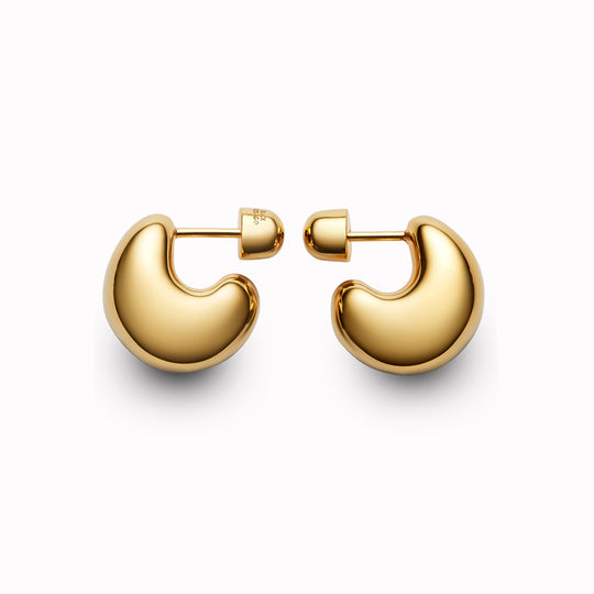 The Tryvann Pillow earring is designed in Denmark and skilfully crafted in 925 recycled sterling silver and plated with either White Rhodium or 18ct Gold, It is a chunky half-hoop earring that is Nickel free and hypoallergenic.